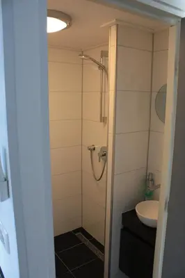 a bathroom with a shower and a sink at Bed & Breakfast Aalsmeer in Aalsmeer