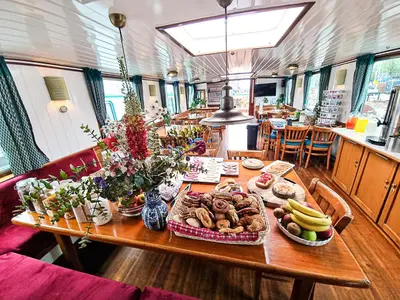 a table with plates of food on top at Amsterdam Hotelboat in Amsterdam