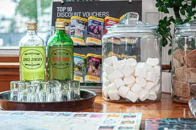 a table topped with glasses and bottles of alcohol at Amsterdam Hotelboat in Amsterdam