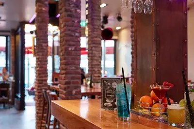 a table in a restaurant with a bowl of fruit on it at Damrak Short Stay Amsterdam in Amsterdam