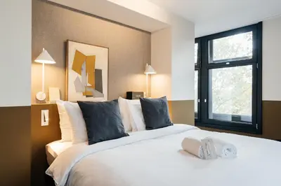 a bedroom with a large white bed with a window at The Hunfeld in Utrecht