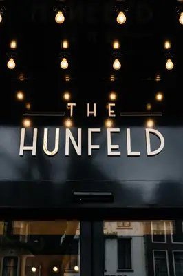 a sign that says the hunted on a store window at The Hunfeld in Utrecht