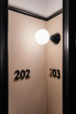 a room with a door with a light and signs at The Hunfeld in Utrecht