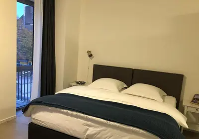 a bed with two pillows in a room with a window at B&B Mondriaan in Amsterdam