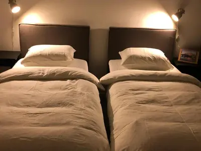 two beds sitting next to each other in a bedroom at B&B Mondriaan in Amsterdam