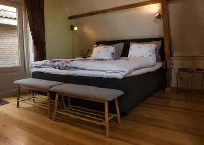 a bedroom with a bed with a canopy at Com-In in Alkmaar