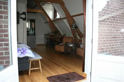an open door to a dining room with a table at Com-In in Alkmaar