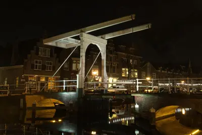 a bridge over a body of water at night at Com-In in Alkmaar