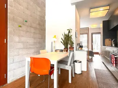 a kitchen with a white table and orange chairs at BB in Amsterdam, 35m2, gratis parkeren in Amsterdam