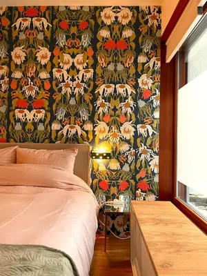 a bedroom with a bed and a wall with a wallpaper at BB in Amsterdam, 35m2, gratis parkeren in Amsterdam