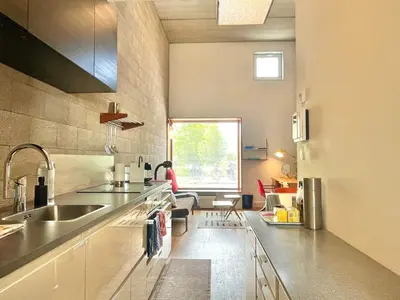 a large kitchen with a sink and a window at BB in Amsterdam, 35m2, gratis parkeren in Amsterdam