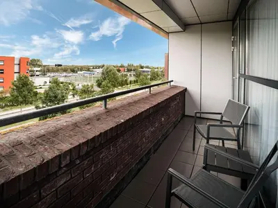 a balcony with chairs and a view of the city at Executive Residency by Best Western Amsterdam Airport in Hoofddorp