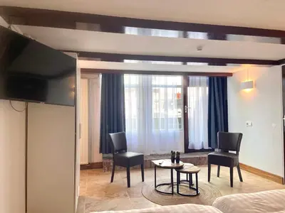 a room with a bed and two chairs and a table at Bed & Ontbijt Haddock in Almere