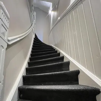 a staircase in a building with black steps at Grand Central Suites in Zandvoort