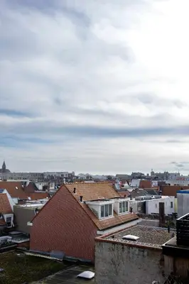 a view of a city with roofs and buildings at Grand Central Suites in Zandvoort