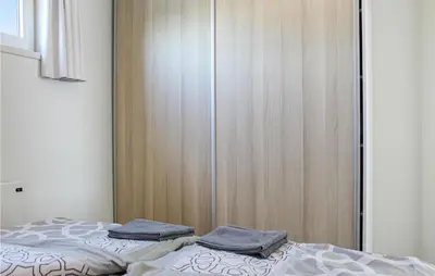 a bedroom with a closet with two pillows on a bed at D'azur in Aalsmeer