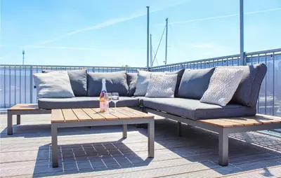 a blue couch sitting on top of a roof at D'azur in Aalsmeer