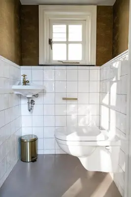 a white bathroom with a toilet and a sink at Small Luxury Boutique Hotel Wilma J in Vinkeveen