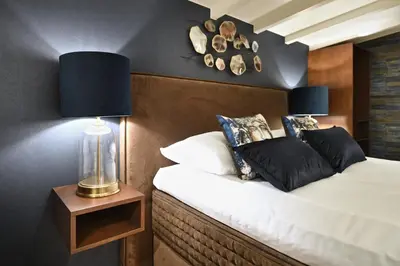 a bedroom with a bed and a lamp on a table at Small Luxury Boutique Hotel Wilma J in Vinkeveen