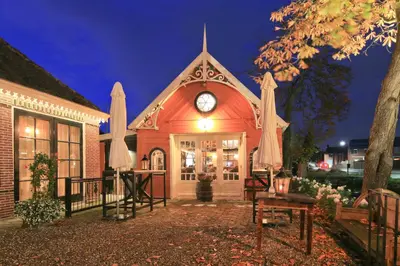 a building with a clock on the front of it at Small Luxury Boutique Hotel Wilma J in Vinkeveen