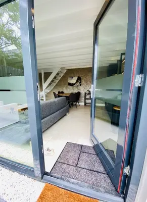 a glass door leading into a living room at Duinzand in Noordwijk aan Zee