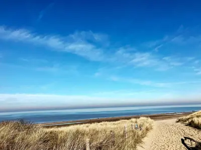 a sandy path to the ocean on a beach at Duinzand in Noordwijk aan Zee