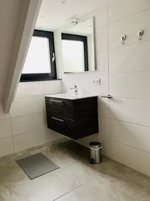 a bathroom with a sink and a mirror at Duinzand in Noordwijk aan Zee