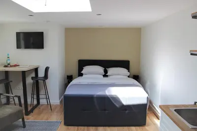 a bedroom with a bed and a desk and a table at Southpoint Zandvoort & private parking in Zandvoort