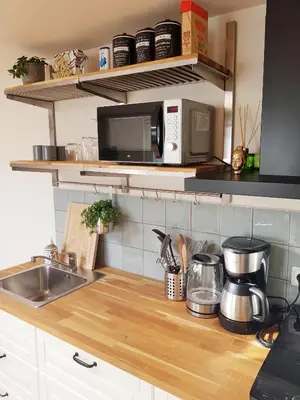 a kitchen counter with a sink and a microwave at Southpoint Zandvoort & private parking in Zandvoort