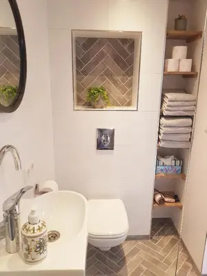 a bathroom with a white toilet and a sink at Southpoint Zandvoort & private parking in Zandvoort