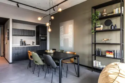 a dining room with a black table and chairs at Hilversum City Apartments in Hilversum