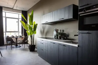 a kitchen with a sink and a table with chairs at Hilversum City Apartments in Hilversum