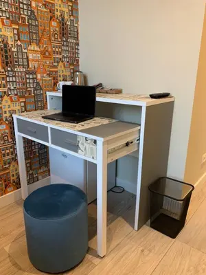 a desk with a laptop computer on top of it at RoomWest in Amsterdam