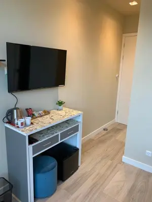 a living room with a television on a table at RoomWest in Amsterdam