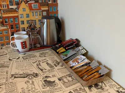 a table with a tray of utensils and a coffee maker at RoomWest in Amsterdam