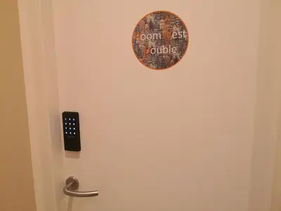 a door with a round sign on it at RoomWest in Amsterdam