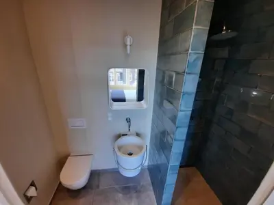 a bathroom with a toilet and a shower at RoomWest in Amsterdam