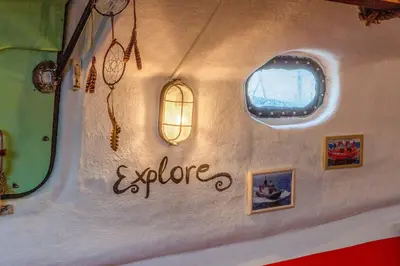 a wall of a boat with a window and the word explore at PolarStern - unique boatstay! in Monnickendam