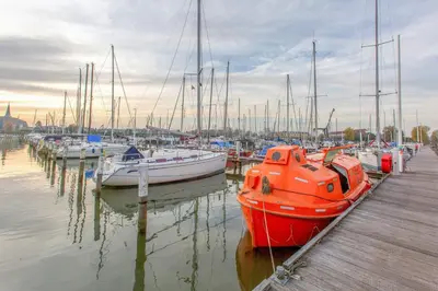 a group of boats are docked in a marina at PolarStern - unique boatstay! in Monnickendam