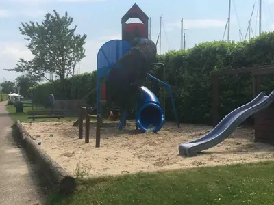 a playground with a slide in a park at PolarStern - unique boatstay! in Monnickendam