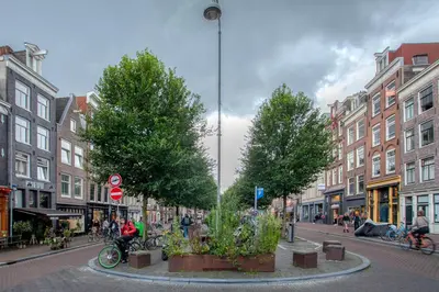 a city street with trees and people riding bikes at B&B 1971 Hazenstraat - Shared Bathroom in Amsterdam