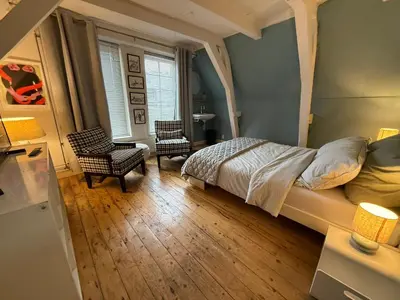 a bedroom with a bed and two chairs at B&B 1971 Hazenstraat - Shared Bathroom in Amsterdam