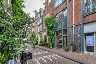 a street with buildings and a bike parked on the street at B&B 1971 Hazenstraat - Shared Bathroom in Amsterdam