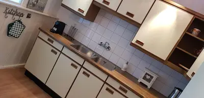 a kitchen with white cabinets and a sink at Ontbijt bij De Boerenmeid in Hoogwoud