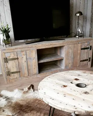 a wooden entertainment center with a flat screen tv at Ontbijt bij De Boerenmeid in Hoogwoud