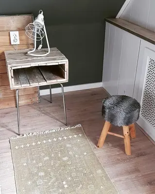 a living room with a table and a stool and a chair at Ontbijt bij De Boerenmeid in Hoogwoud