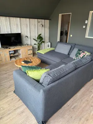 a living room with a couch and a table at Ontbijt bij De Boerenmeid in Hoogwoud
