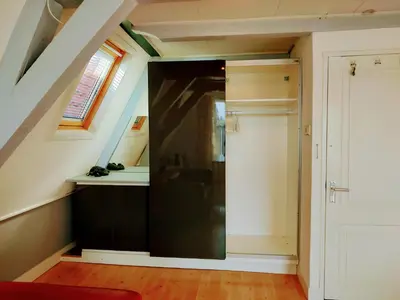 a bathroom with a black door in a attic at B&B Hart van Leiden in Leiden
