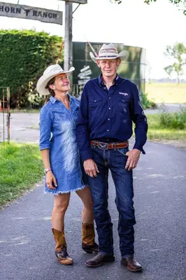 a man and a woman standing on a road at Bed&Bbq Longhornranch in Akersloot