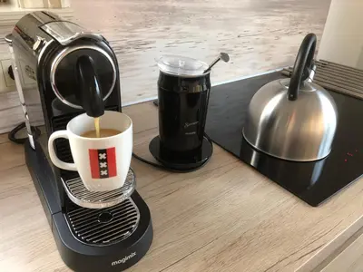 a coffee maker sitting on a counter with a cup of coffee at Amsterdam Twiskehouse in Den Ilp